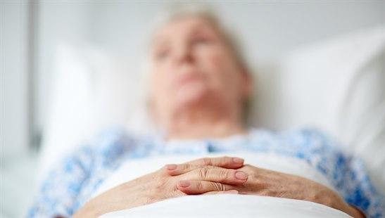Old woman in hospital bed