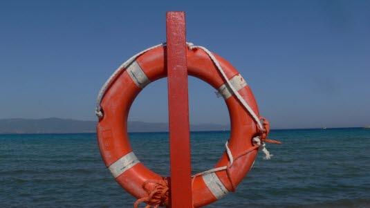 Nærbilde av en rød livbøye med fire hvite striper