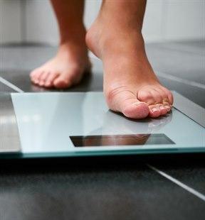 Fotoet viser en fot som går opp på vekten