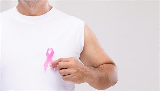 Illustrasjonsfoto av mann som holder rosa sløyfe-symbolet for brystkreftkampanjen foran brystkassen sin